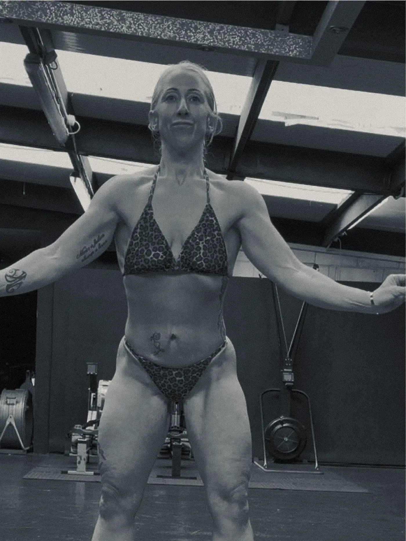 The same client in competition condition inside a training facility, showing clear muscle definition