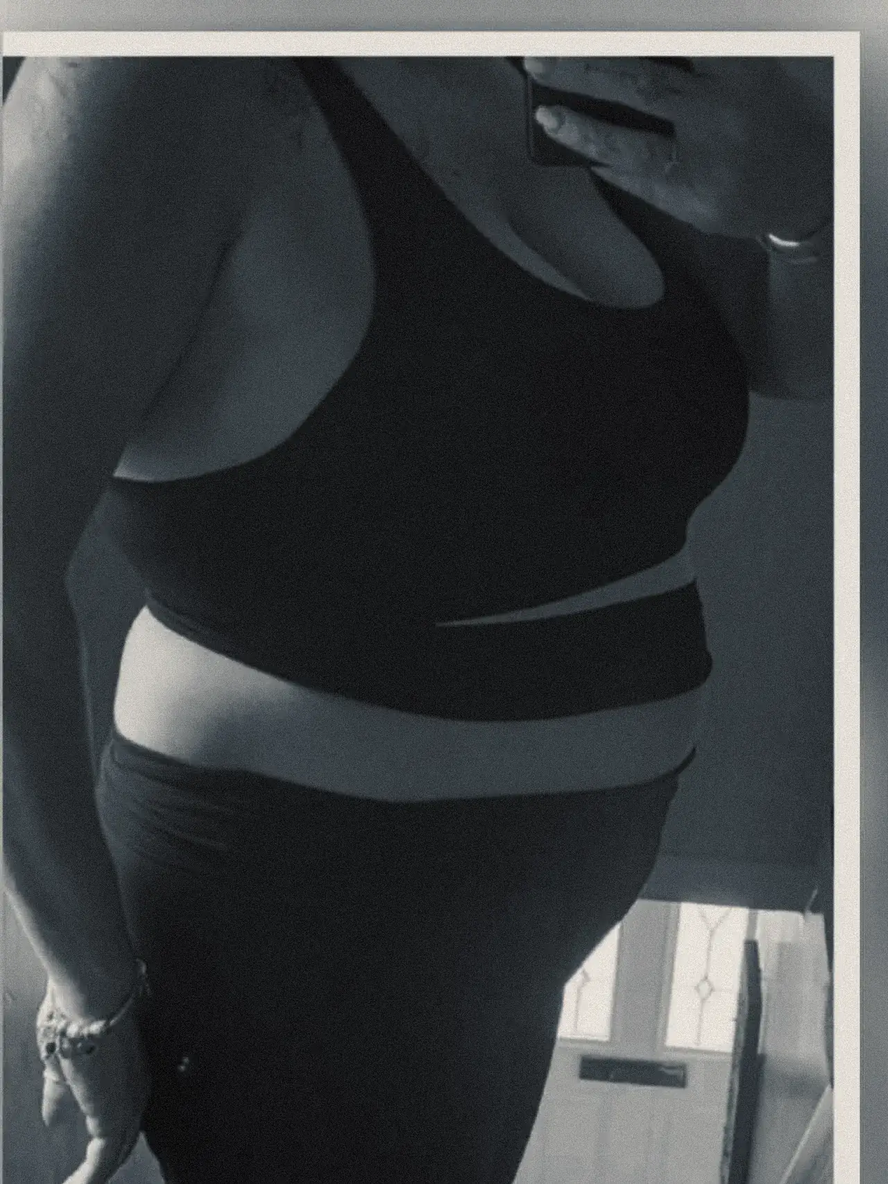 A client photographed side on at the start of her programme