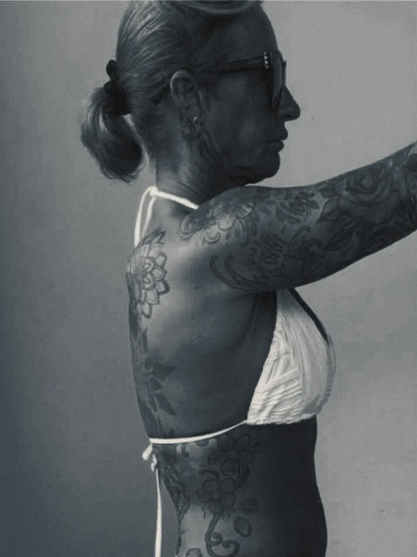A client photographed side on at the start of her programme