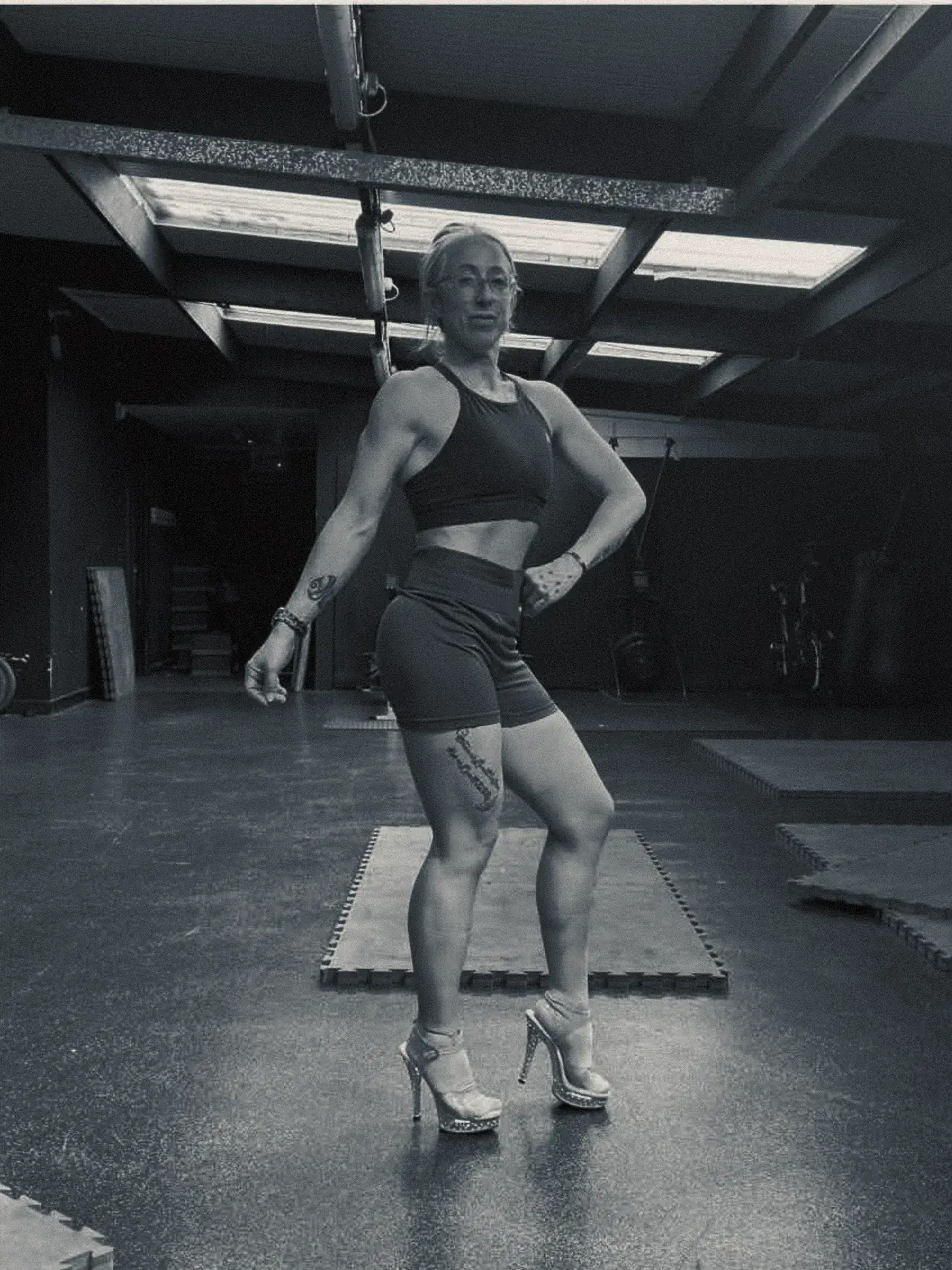 The same client afterwards in a training gym, leaner with visible abdominal and leg definition